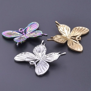 Detailed view of 18k gold, silver, and rainbow stainless steel butterfly pendants