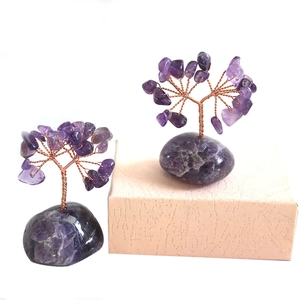 Detailed view of handmade amethyst crystal money trees with twisted copper wire on a base