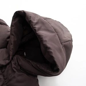 Detailed close-up of a dark brown waterproof hooded jacket with a matte finish and padding