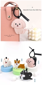 Detailed view of leather dog charms featuring Corgi and Husky with durable stitching