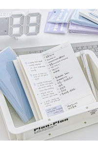 Detail view of Plan-Plan daily planner showing Check/List layout on an aesthetic desk