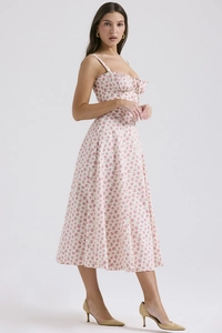Detailed view of the pink floral pattern and heart-shaped neckline on a midi dress