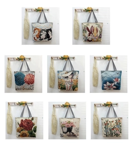 Detail display of multiple canvas tote bags with cute animal and floral art prints