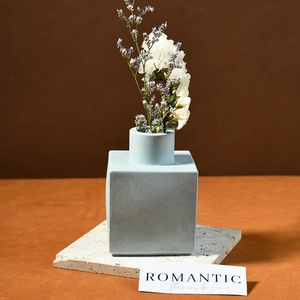 Modern minimalist square geometric vase in matte gray-blue finish with dry flowers
