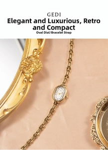 Close-up of a vintage gold quartz watch with oval dial on champagne satin fabric