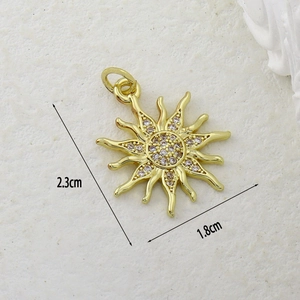Detail view of gold sun pendant with cubic zirconia and size dimensions 2.3x1.8cm