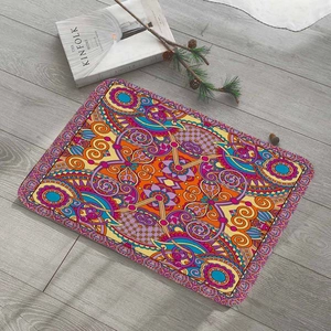 Overhead view of colorful bohemian flannel floor mat with mandala pattern on gray wood floor