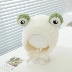Close-up of plush frog hat with green eyes and cozy earflaps for toddlers and babies