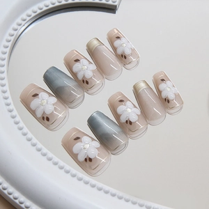 Cat eye press-on nails with 3D white flowers and French gold gradient in long coffin shape