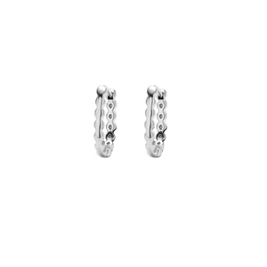 Detailed close-up of silver wavy earrings with sparkling inlaid cubic zirconia stones