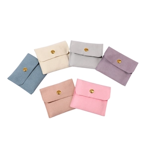 Multicolor microfiber jewelry pouches with gold snap buttons in a fan arrangement