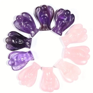 Detailed arrangement of hand-carved amethyst and rose quartz angel crystal ornaments