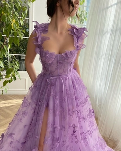 Close-up of purple tulle dress with 3D butterfly embroidery and high slit detail