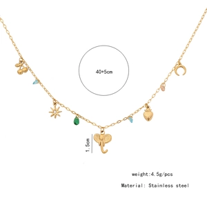 Detailed view of gold stainless steel necklace with elephant, cherry, and moon charms