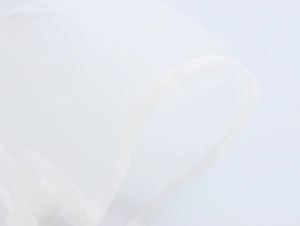 Macro detail showing fine stitching and white translucent mesh organza fabric texture