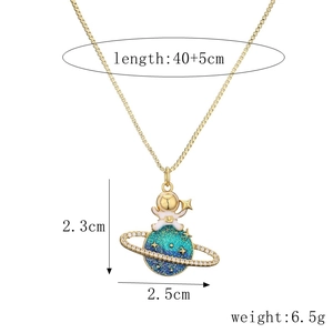 Close-up of gold astronaut pendant on blue planet with chain dimensions and weight info