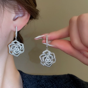 Detailed close-up of a zircon floral drop earring featuring multi-layered silver petals