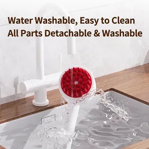 Waterproof silicone scalp massager brush with red bristles under running water faucet