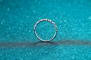 Macro detail of S925 sterling silver twisted rope ring with sparkling pave moissanite stones