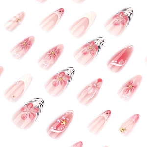 Short almond press-on nails with 3D embossed flowers, pearls, and pink zebra patterns