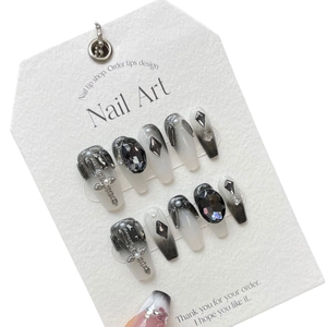 Dark gradient handmade press-on nails with silver crosses and black gemstones on white card