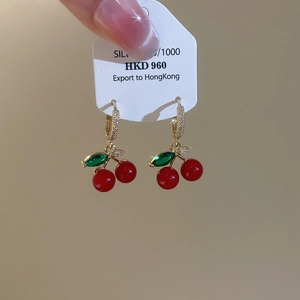 Detail of red cherry earrings with green leaf stones and S925 silver gold-plated hooks