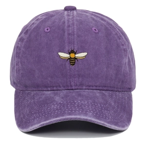 Detail of vintage washed purple baseball cap featuring a delicate bee embroidery pattern