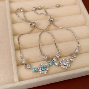 Detailed macro view of adjustable silver bracelets with blue zircon snowflake charms