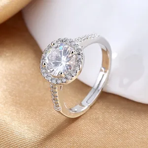 Macro shot of a silver halo engagement ring with sparkling zircon in a luxury silk setting