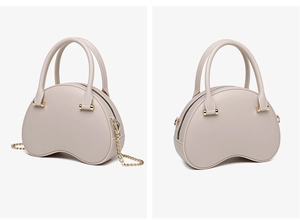 Detailed view of beige PVC jelly handbag featuring golden chain strap and crescent design