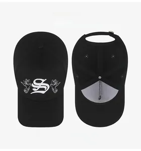 Detail of gothic S letter and pigeon embroidery on black adjustable baseball cap