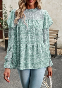 Detailed view of green floral long sleeve blouse with ruffled shoulders and layered hemline