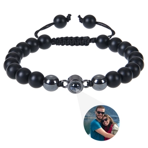 Detailed view of the 8mm black volcanic stone bracelet with a custom photo projection stone