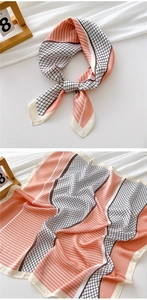 Detail view of the geometric patterned silk scarf featuring pink and white color blocks