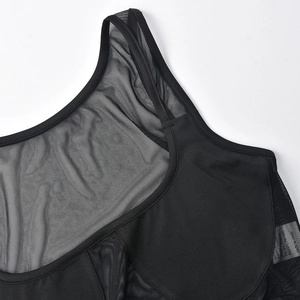 Close-up of black mesh cutout crop top showing high-quality stitching and neck detail