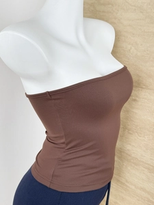 Macro shot of dark brown strapless tube top featuring high elasticity vertical ribbed texture