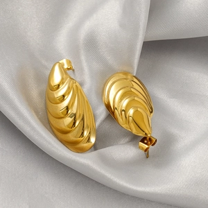 Polished gold shell-shaped stainless steel earrings on silk, minimalist jewelry