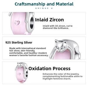 Macro detail of S925 silver cat charm with pink heart and 3A cubic zirconia stones