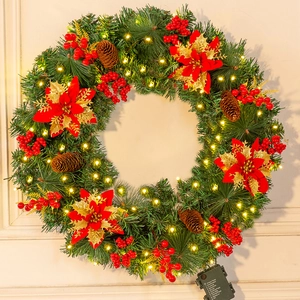 Detail of flocked Christmas wreath with pine cones, berries, poinsettia and LED lights