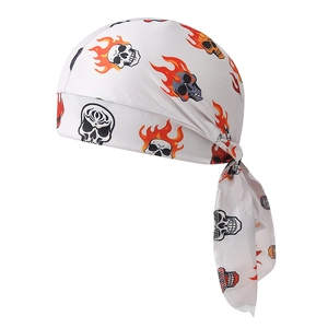 Detail of pirate bandana with orange flame and black skull print on white fabric