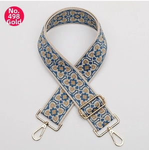 Close-up of ethnic geometric pattern strap with gold metal hardware and adjustable slider