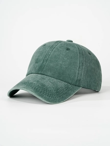Detailed view of dark green washed cotton baseball cap with six-panel design and curved brim