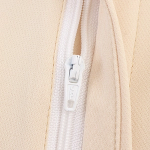Close-up of invisible zipper and woven fabric detail on a beige elegant suit set