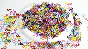 Macro view of colorful painted eye pins and screw hooks for DIY jewelry making