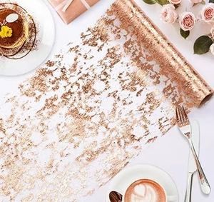 Close-up of rose gold foil mesh table runner with elegant metallic patterns for parties