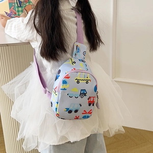 Detail of light blue kids chest bag featuring colorful cartoon car prints and purple strap
