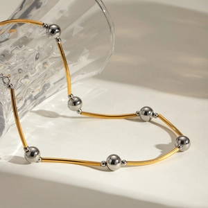 Gold and silver two-tone curved tube and bead necklace in polished stainless steel