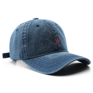 Retro denim baseball cap in dark blue with red embroidered letter W on white background