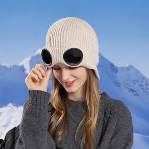 Winter knitted ear protection hat with stylish built-in goggles for women in off-white