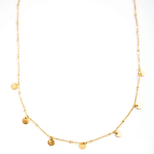 Close-up of gold layered necklace featuring multiple flat round disc charms on fine chains